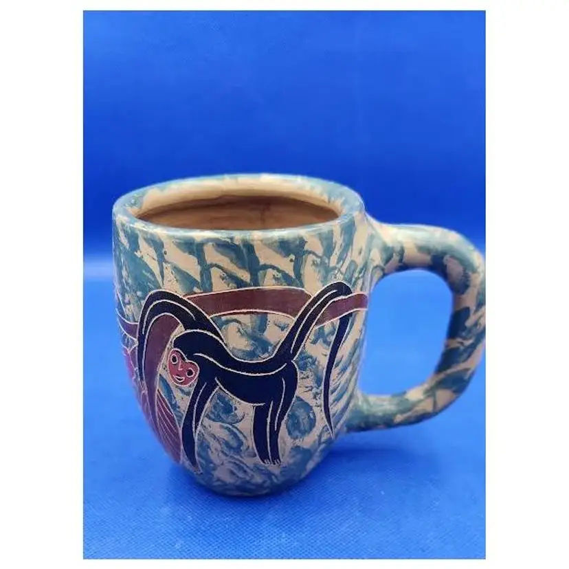 Handmade and painted carved mug with monkey and Tucan