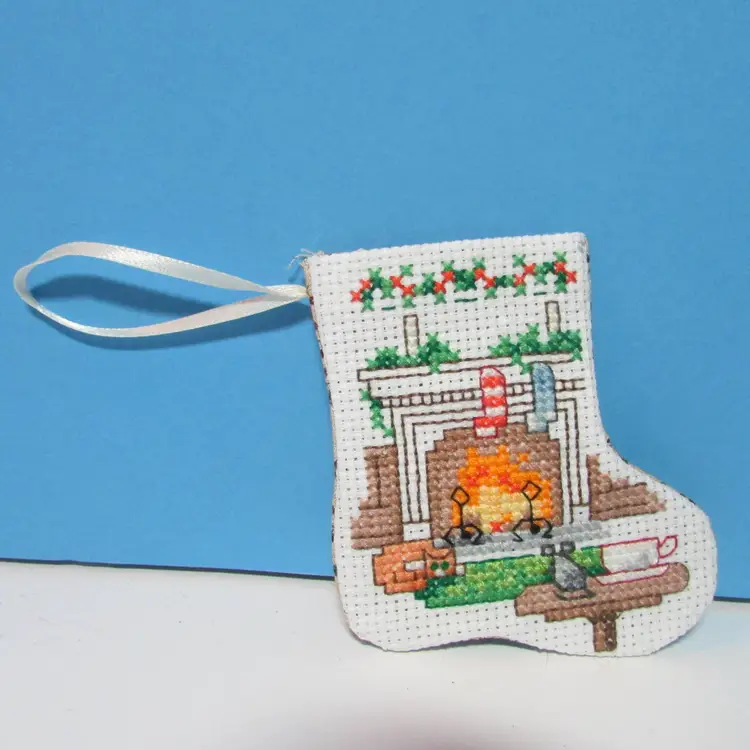completed handmade cross stitch small Christmas stocking ornament fireplace
