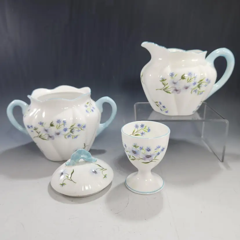 Shelley Blue Rock Covered Sugar & Creamer Set w Matching Egg Cup Bone China Dainty Shape Floral w Blue Trim 4 pc. – England