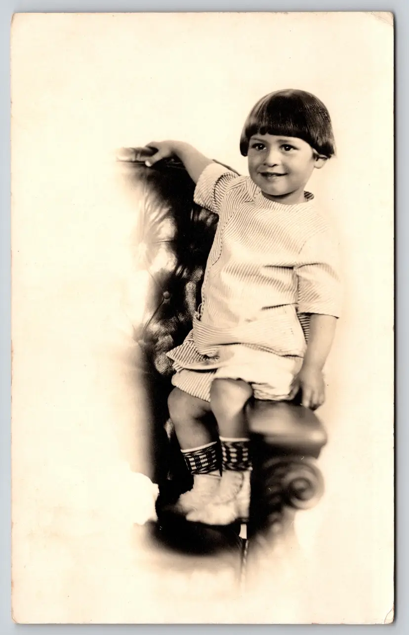 Postcard RPPC Kid with Bowl Cut Seated on Leather Armchair Real Photo Child  - 9085