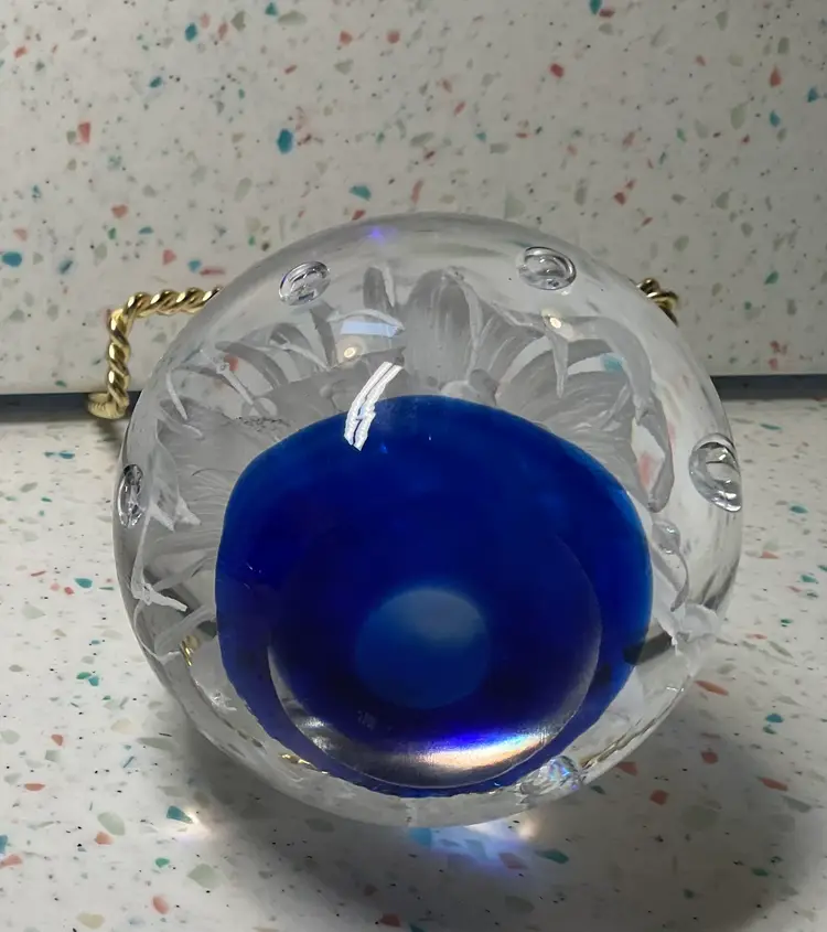 #01 Large blown glass paperweight, 3 1/2” round and high. Rich blue base, white flower, and controlled bubbles.