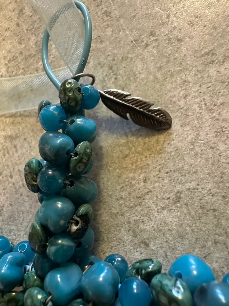 Handcrafted beaded cross ornament with blue glass beads and metal wire