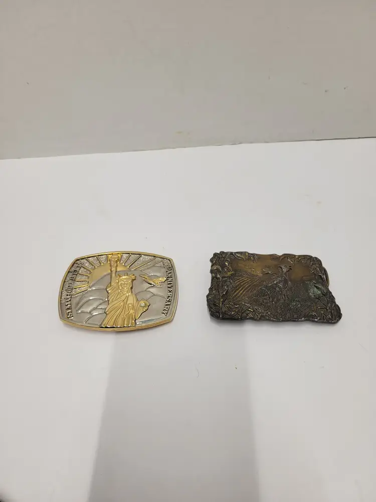 2 belt buckles pheasant and statue of liberty