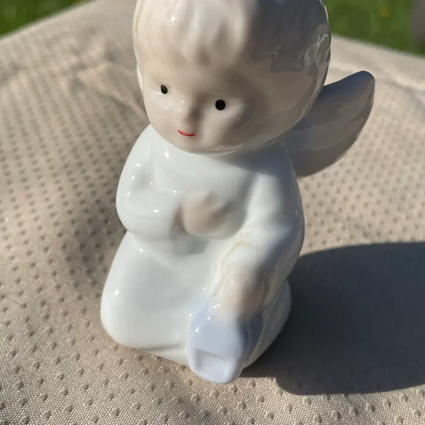 Small Seated Boy Angel Holding A Lantern