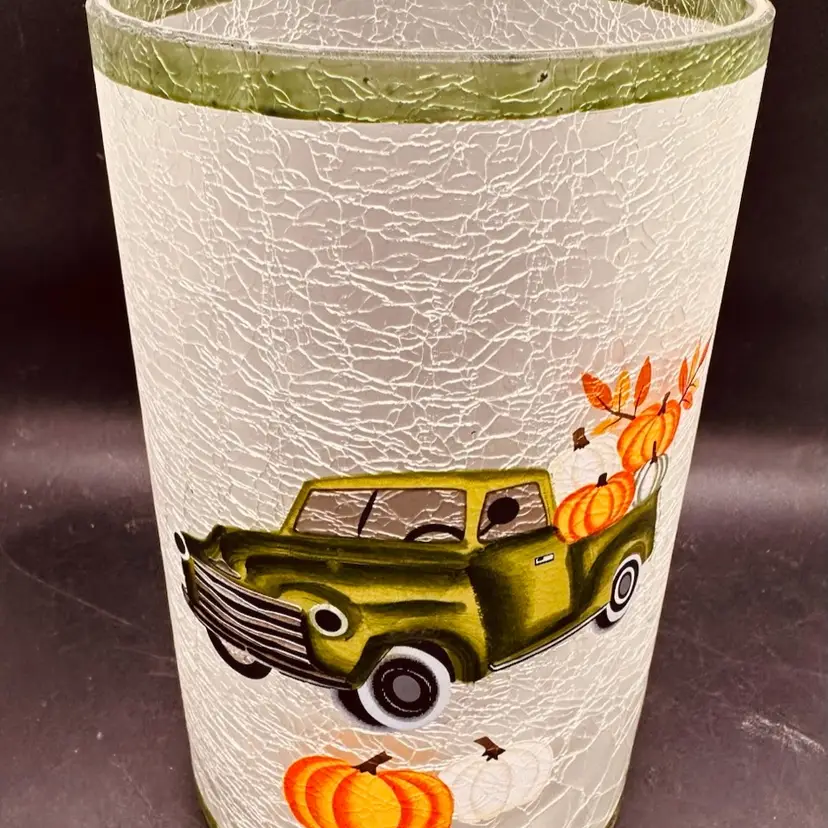 81. Decorative candle sleeve with a fall theme. Vtg. Green truck and pumpkins