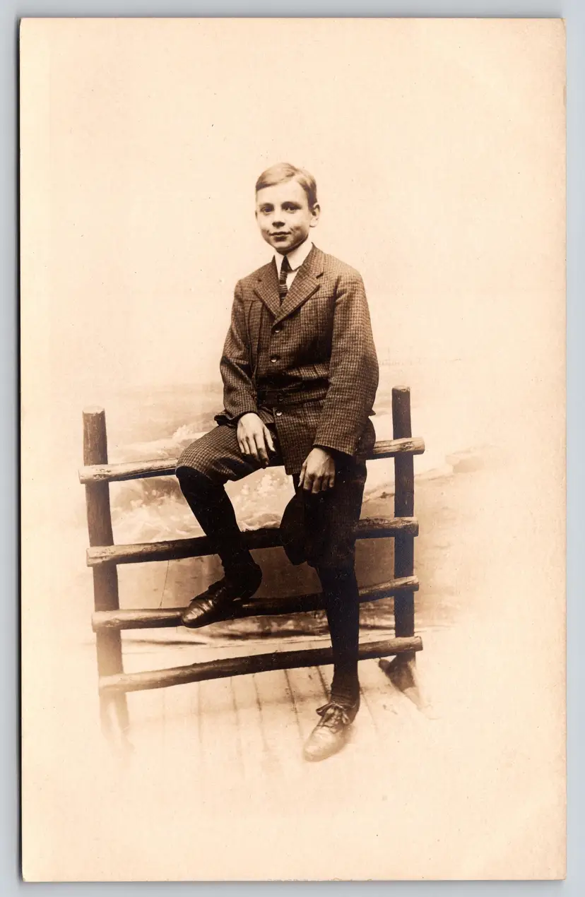 Postcard RPPC Young Man it Checkered Suit Sitting on Fence Real Photo - 9142