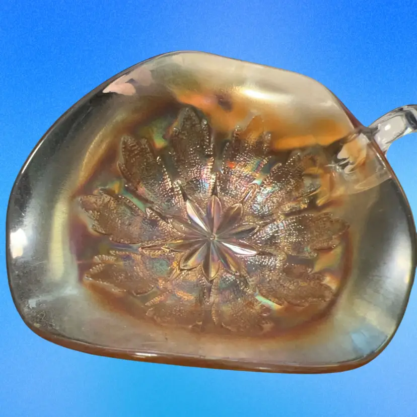 vintage Dugan marigold carnival glass nappy / Trinket dish with a floral pattern.