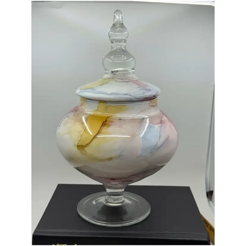 Decorative glass apothecary jar with lid, marbled finish.