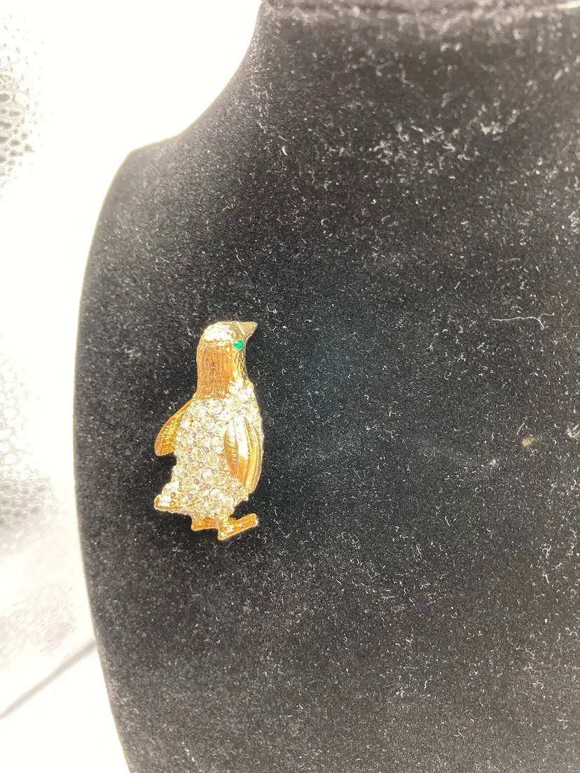 gold-tone penguin brooch adorned with clear rhinestones