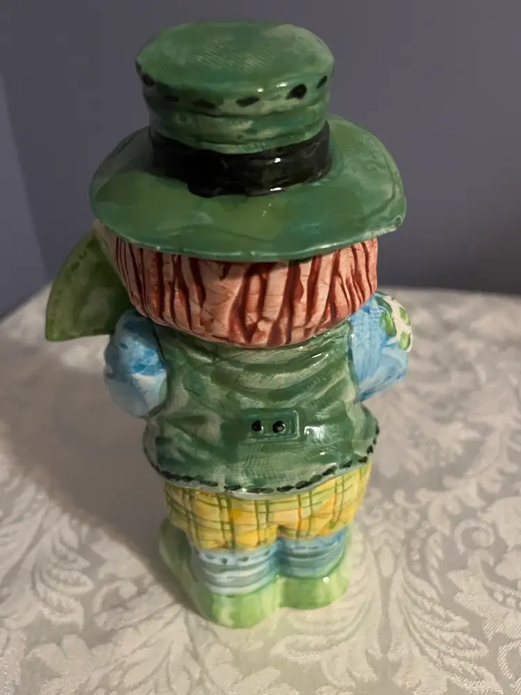 #01 A ceramic leprechaun figurine with "100% IRISH" inscription.
