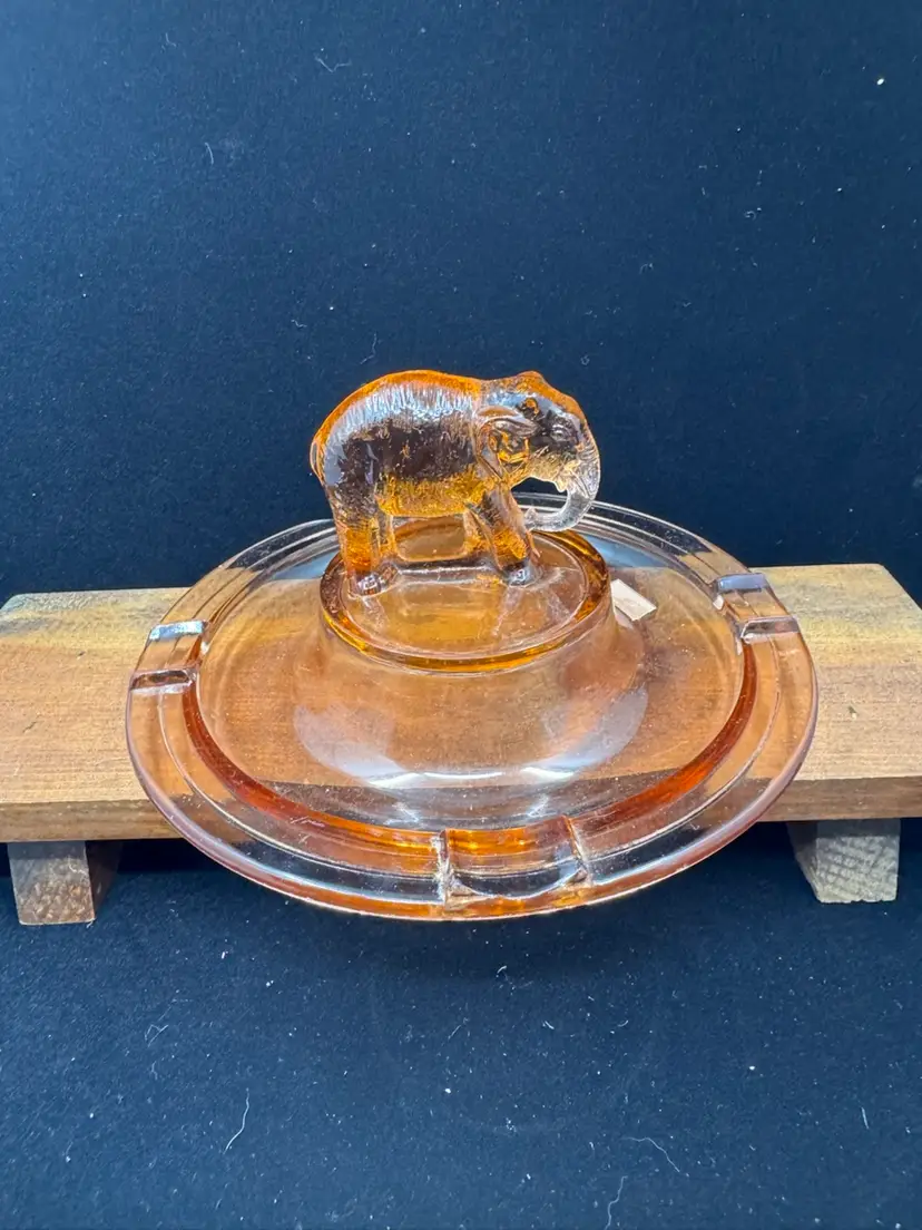 Vintage amber glass ashtray with an elephant figurine