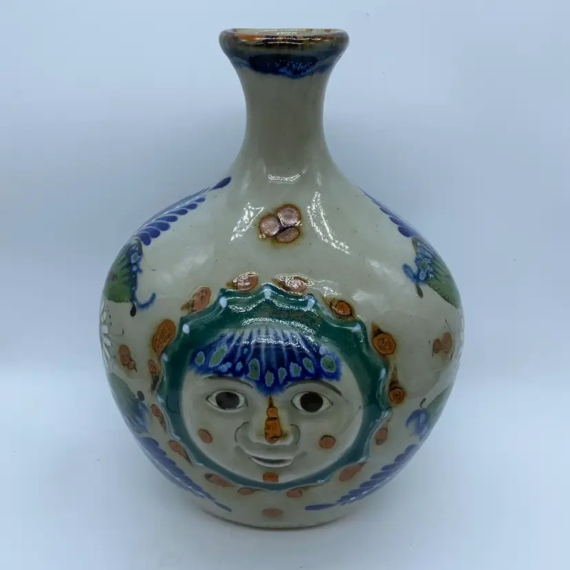 #3002 A 10" x 7" Erandi Tonala pottery vase with a smiling sun face motif Mexico