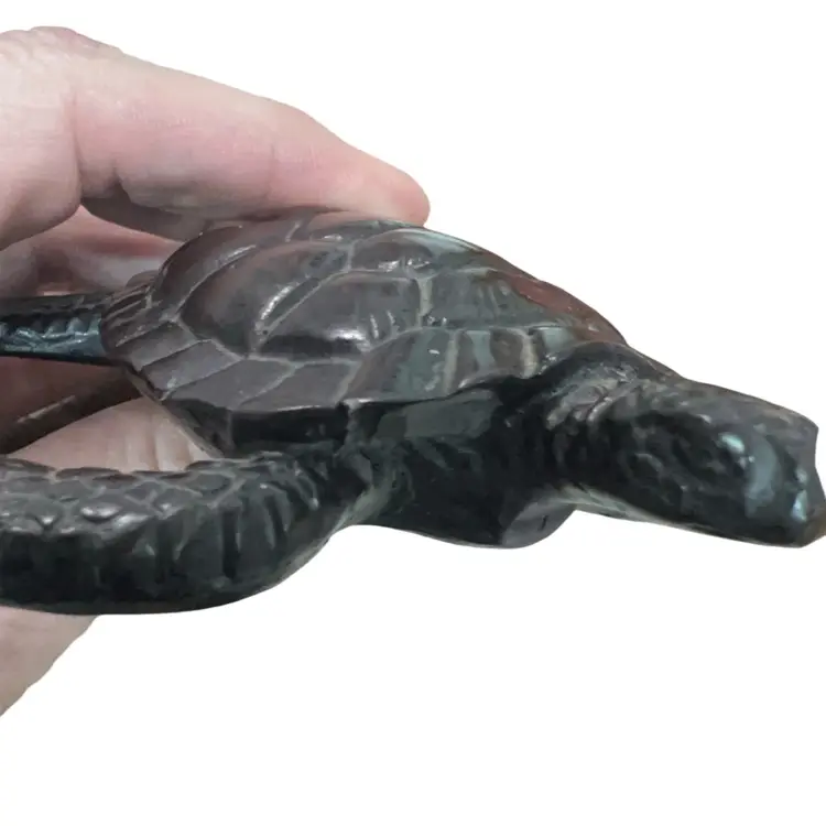 A decorative loggerhead sea turtle figurine, possibly resin , Or Wood..4” Long