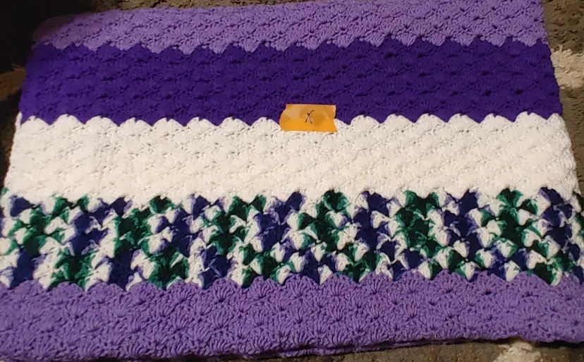 Afghan X- approx size 50 x 72. Purple stripe. As shown.