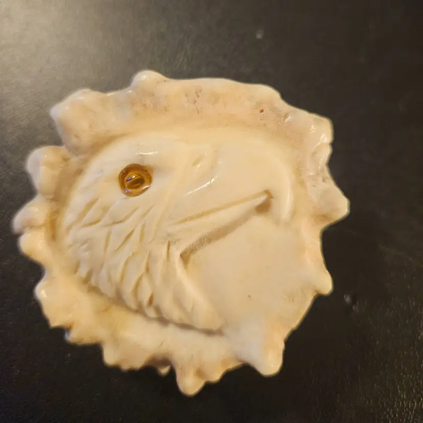carved belt buckle featuring an eagle head