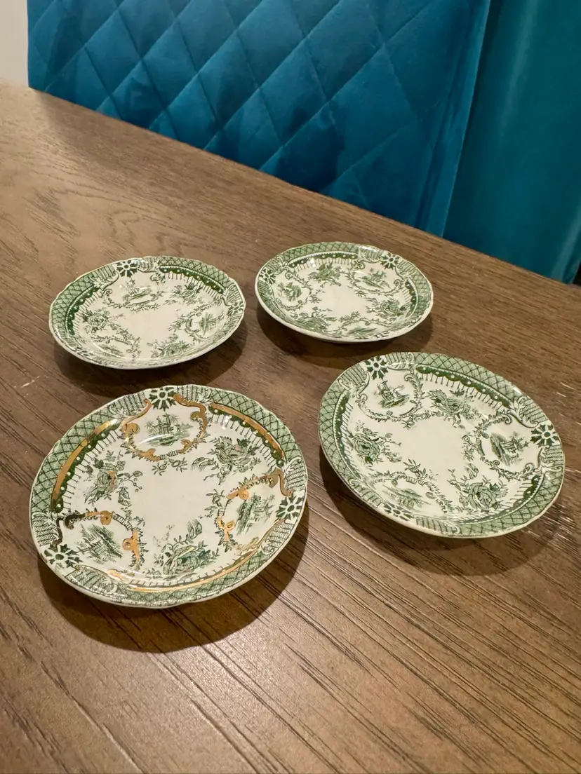Vintage set of 4 butter pats. Only one has the gold details
