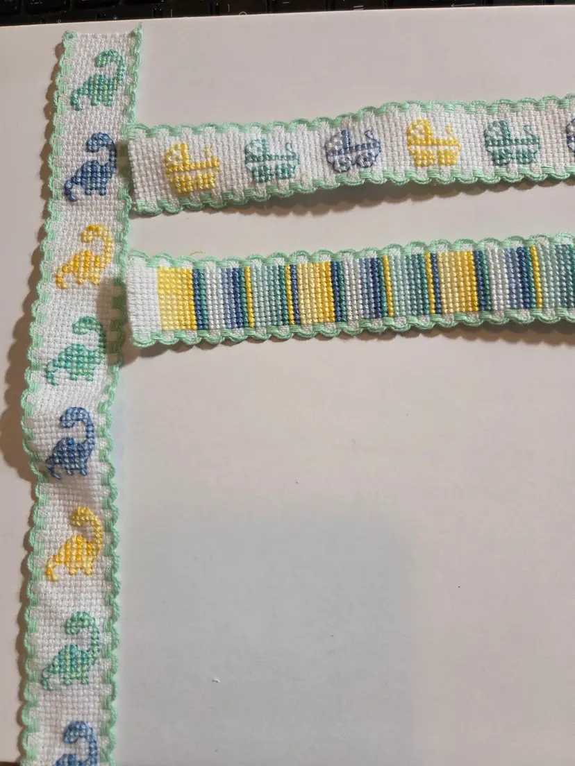 Lot of three Ribband pieces Cross-stitched on dinosaur,  baby carriages, and coordinating yellow, green, and blue stripes to add to craft projects.,