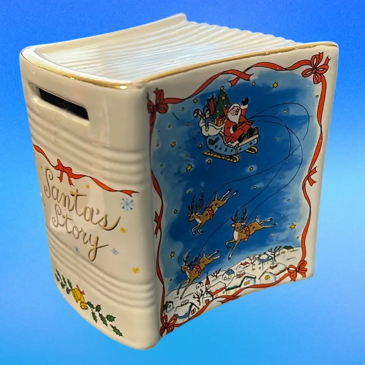Studio Nova ceramic 'Santa's Story' book bank with a Christmas theme. 3” Tall. Excellent Condition, Great Christmas Gift Idea!