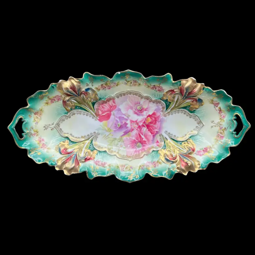 #151A Antique RS Prussia Porcelain Celery Dish. Hand PaintedWith Pink Roses On A Teal Background With Gold Gilt Edges.
Dating 1880 to 1910
