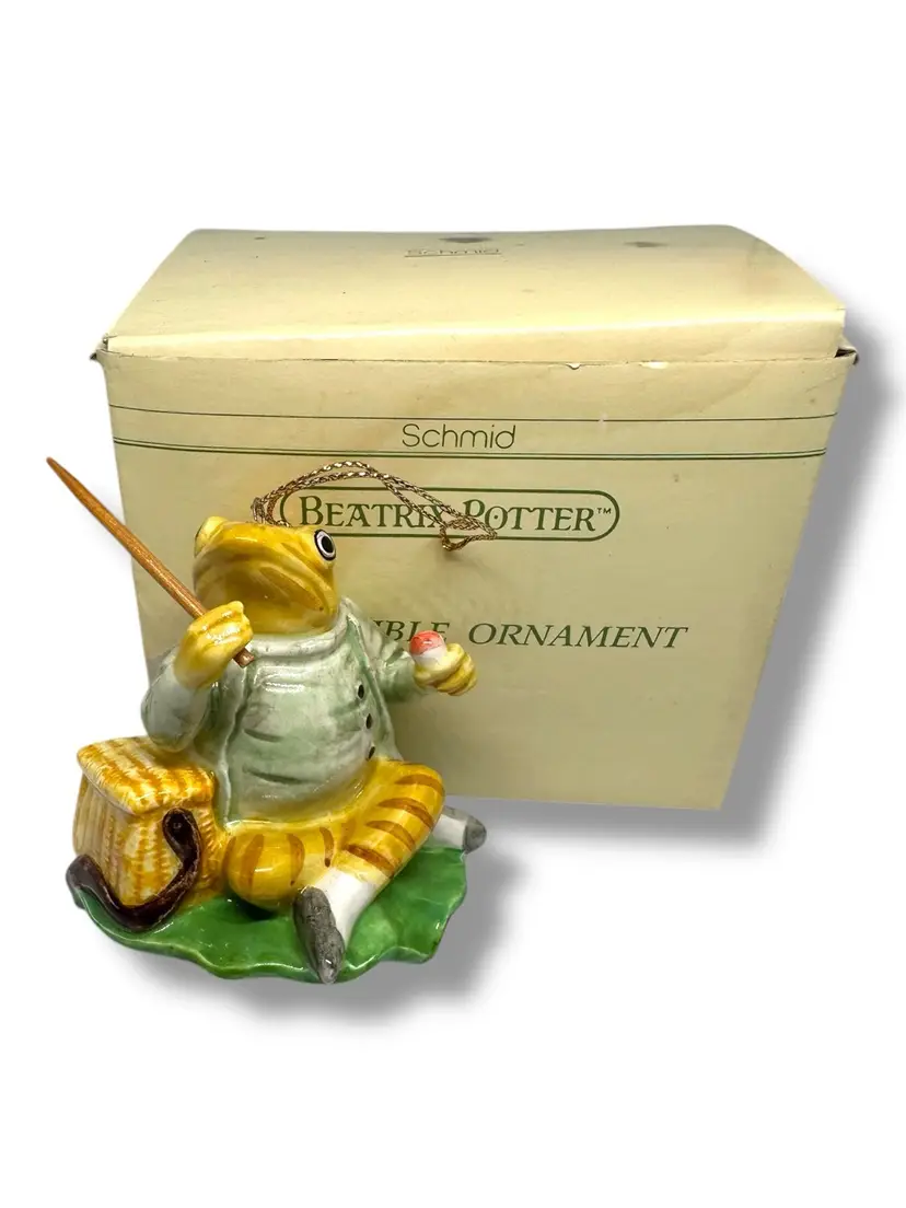 096. Beatrix Potter “Jeremy Fisher” Hand Painted Porcelain Collectible Ornament. Approximately 3 Inches Tall. Comes In Original Box. There Is Some Damage To The Box. Made By Schmid 1993