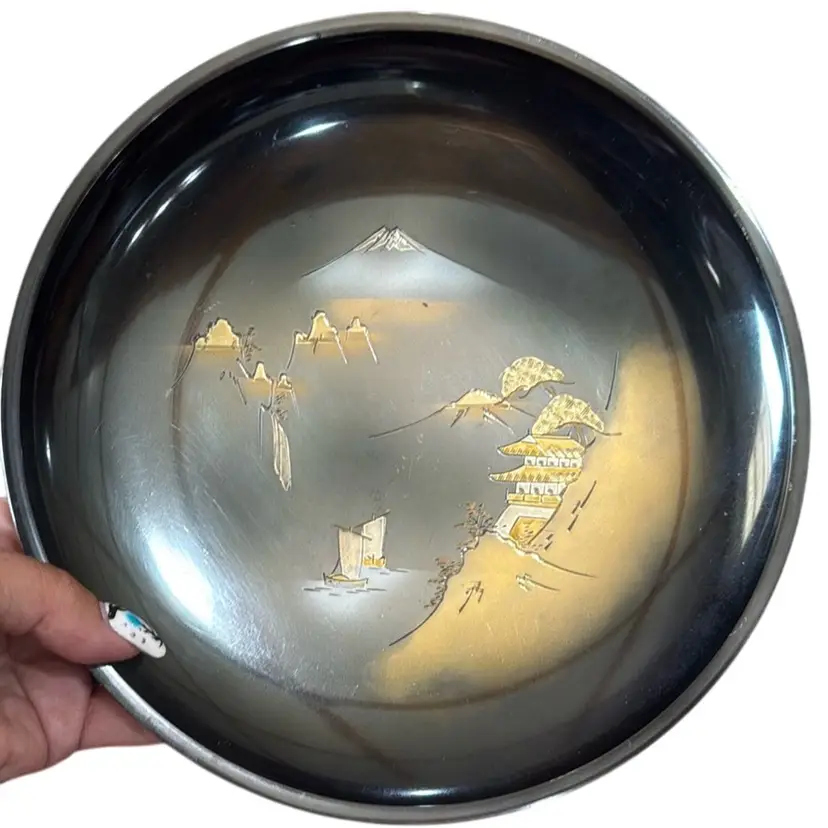vintage Japanese decorative plate or bowl, made of etched brass with a black finish.