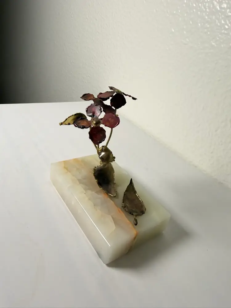 vintage Mid-Century Modern copper or brass flower sculpture on a stone base