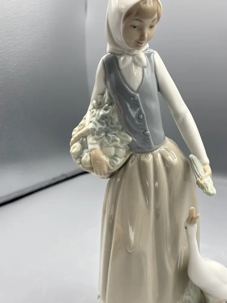 Nao porcelain figure girl with a goose & flowers