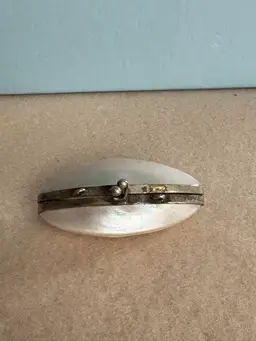 Vintage mother-of-pearl trinket box with metal frame and kiss clasp
