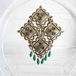 Vintage Sarah Coventry Temple of Lights brooch pin with an articulated style
