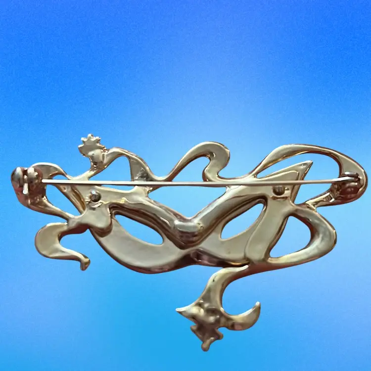 Vintage enameled Mardi Gras masquerade mask brooch. Gold Tone With Purple And Green Enamel Accents And Orange Rhinestones