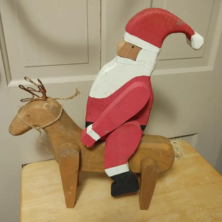 Wood Santa riding a Reindeer. Santa does come off. 17 inches high.