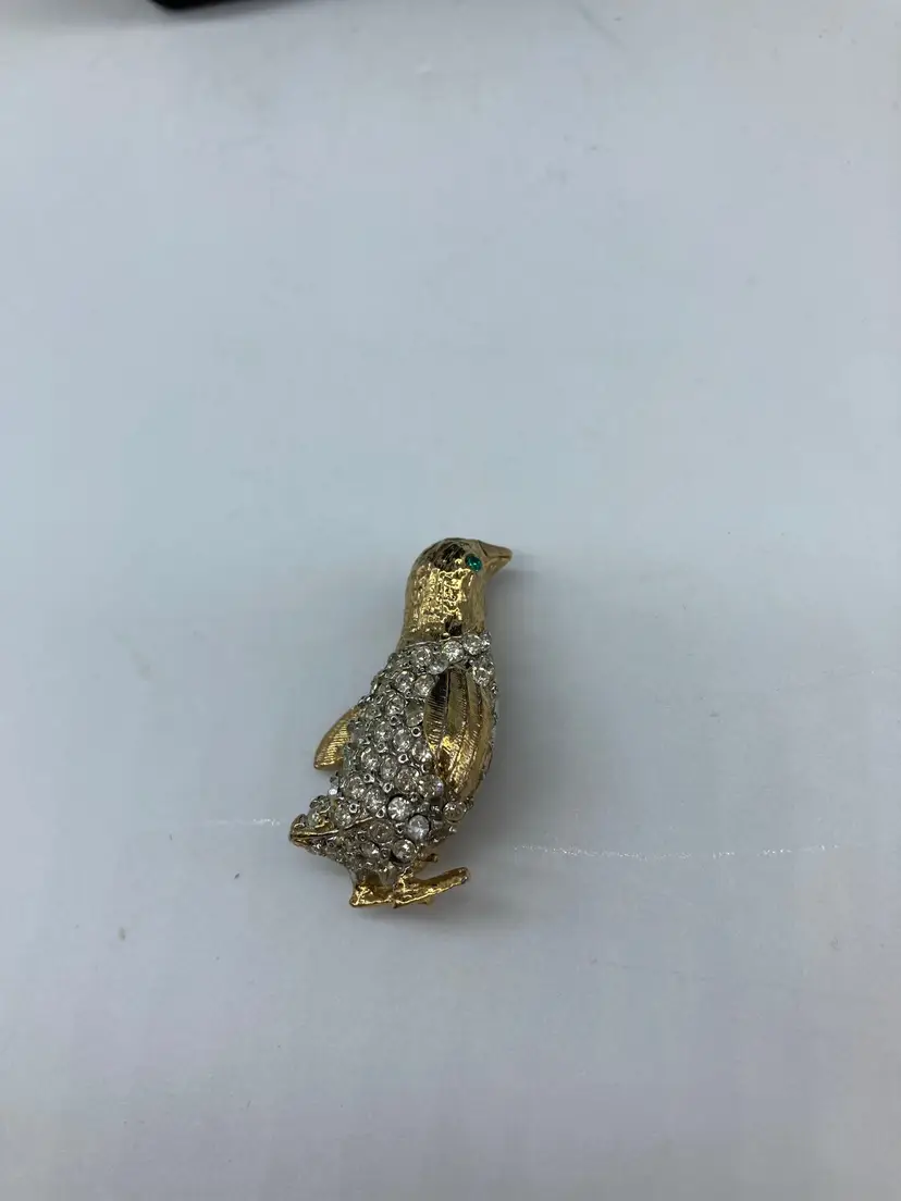 gold-tone penguin brooch adorned with clear rhinestones
