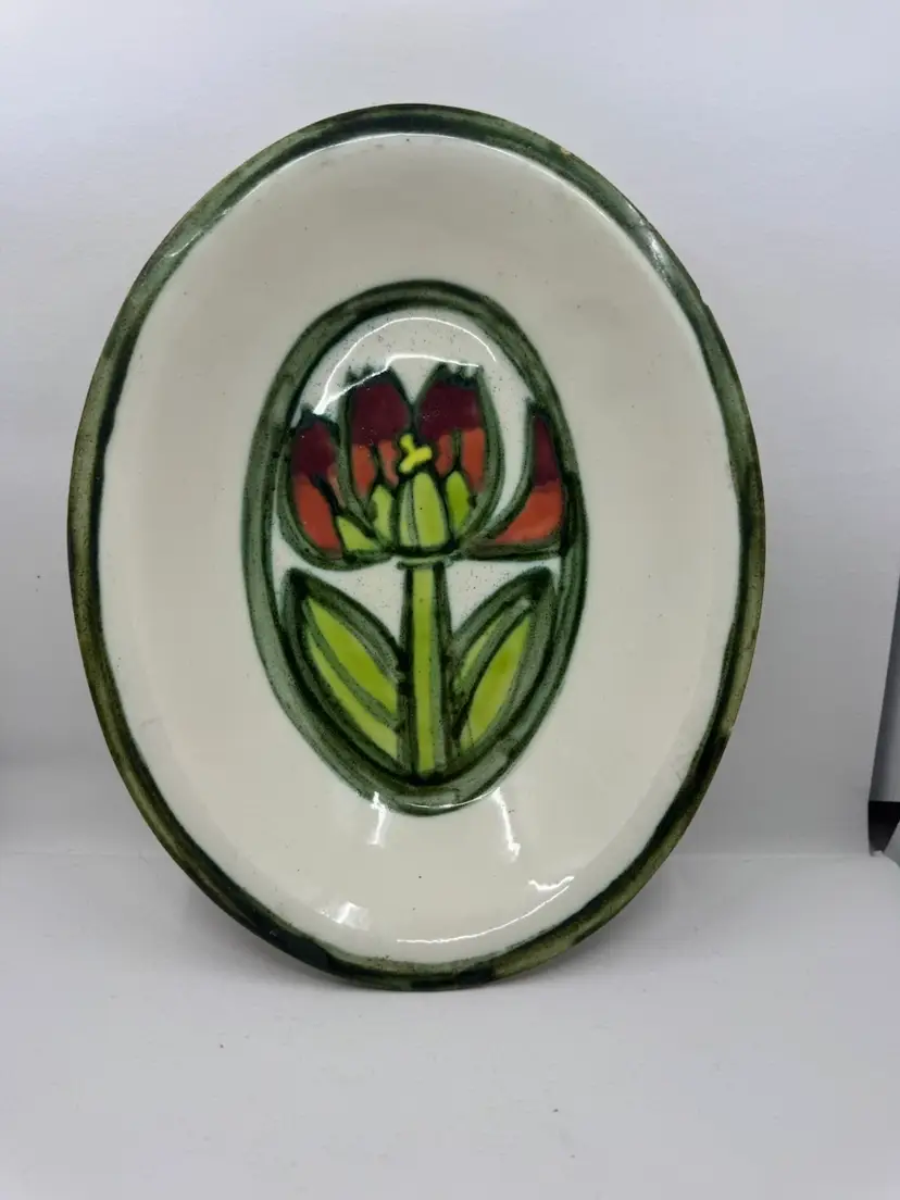 Hand-painted ceramic plate featuring a stylized tulip motif