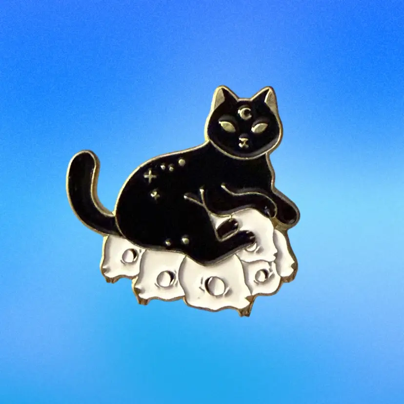 Black Dat on Pillow of White Skulls Lapel Pin