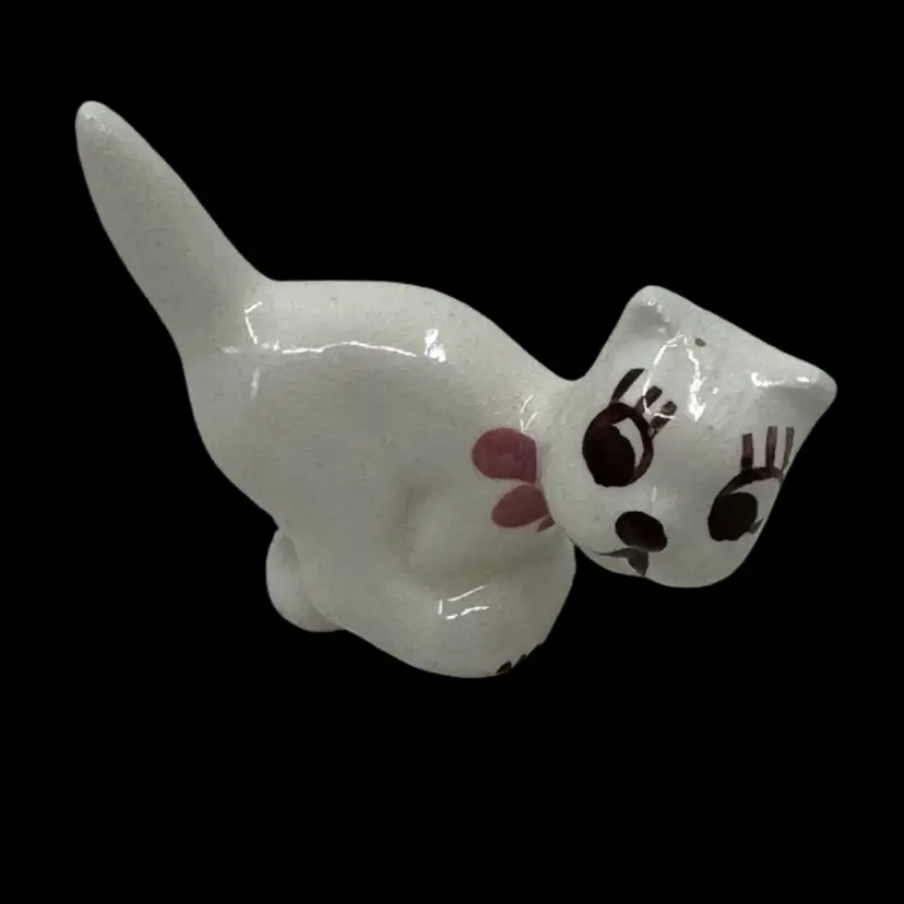 Vintage hand-painted ceramic cat figurine with pink bow and brown eyes. Probably Rio Hondo