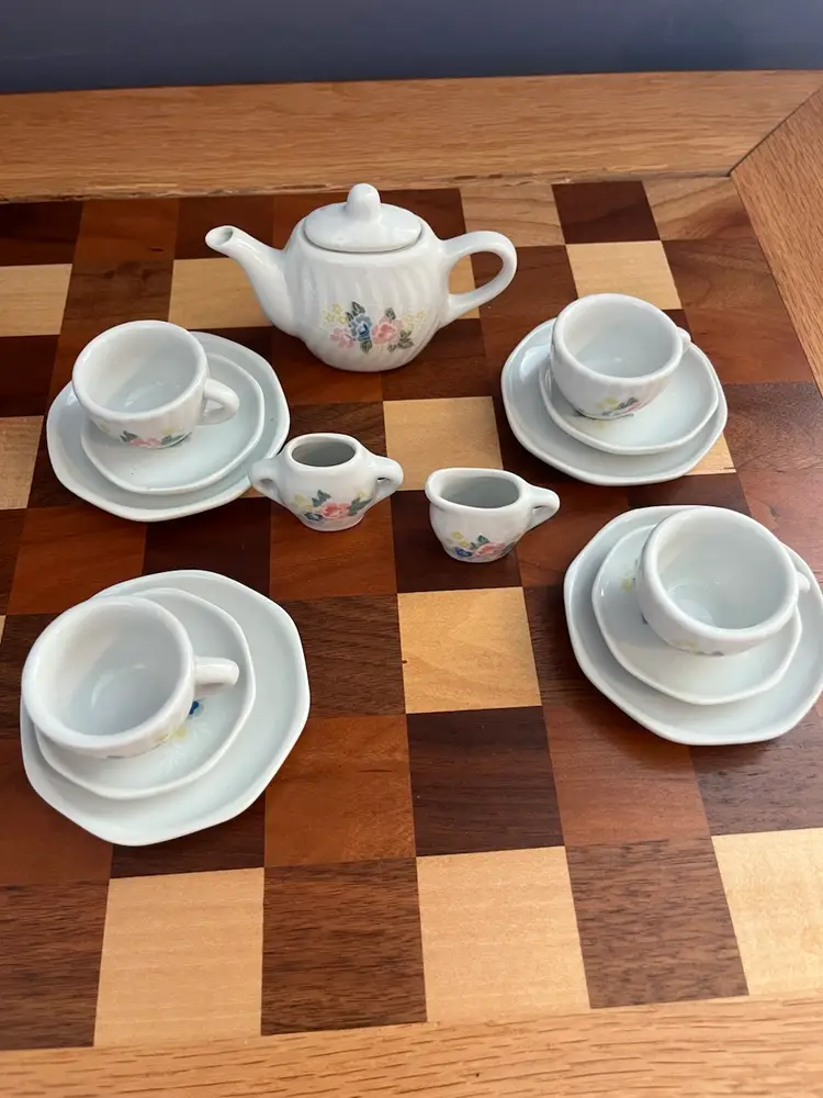 A miniature porcelain toy tea set with floral decoration. -Pretty Port LTD Made In China