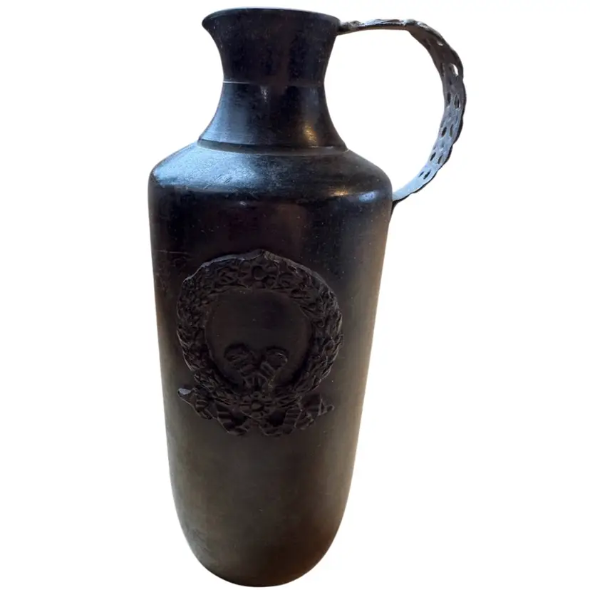bronze pitcher with wreath And decorative handle