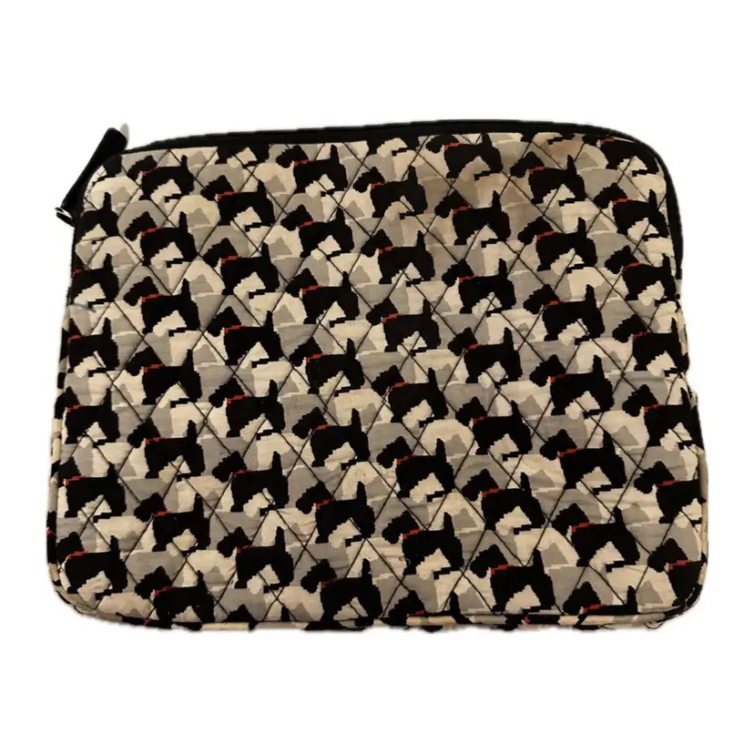 This is a Vera Bradley Scottie Dogs makeup bag, featuring a quilted cotton construction with a black and white terrier pattern