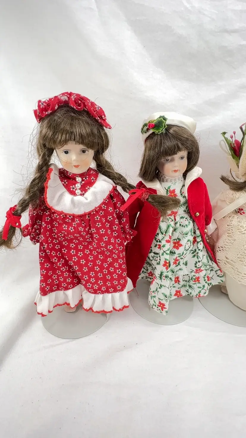 Lot Of 5 Gorham Porcelain Dolls From 1980s. Four Old Fashioned Christmas Series dolls and One January 1985 Dolly of the Month Red/White Dress & Pigtails. Gold Thread Hanging Loops On Back.