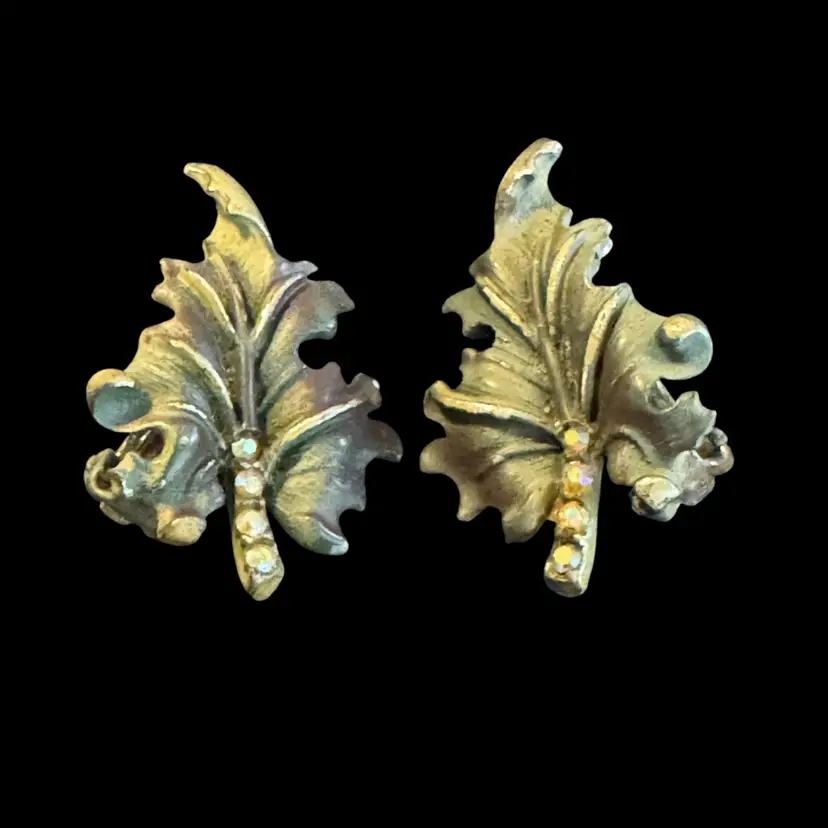Vintage signed BSK (Bauer, Schmidt/Koch) clip-on earrings shaped like stylized maple leaves with rhinestones.