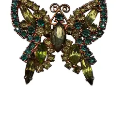 Vintage gold plated green rhinestone butterfly brooch.