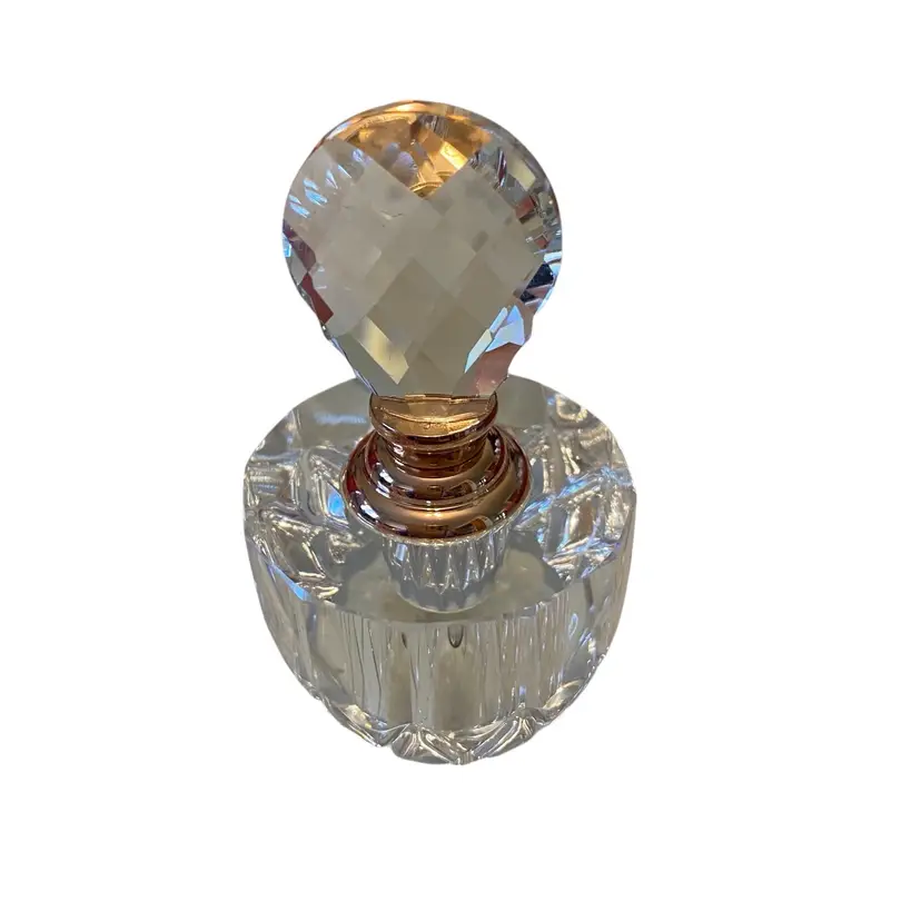 This item is a vintage Oleg Cassini Cristal Parfum bottle featuring a diamond-shaped cut crystal design and a signature stopper