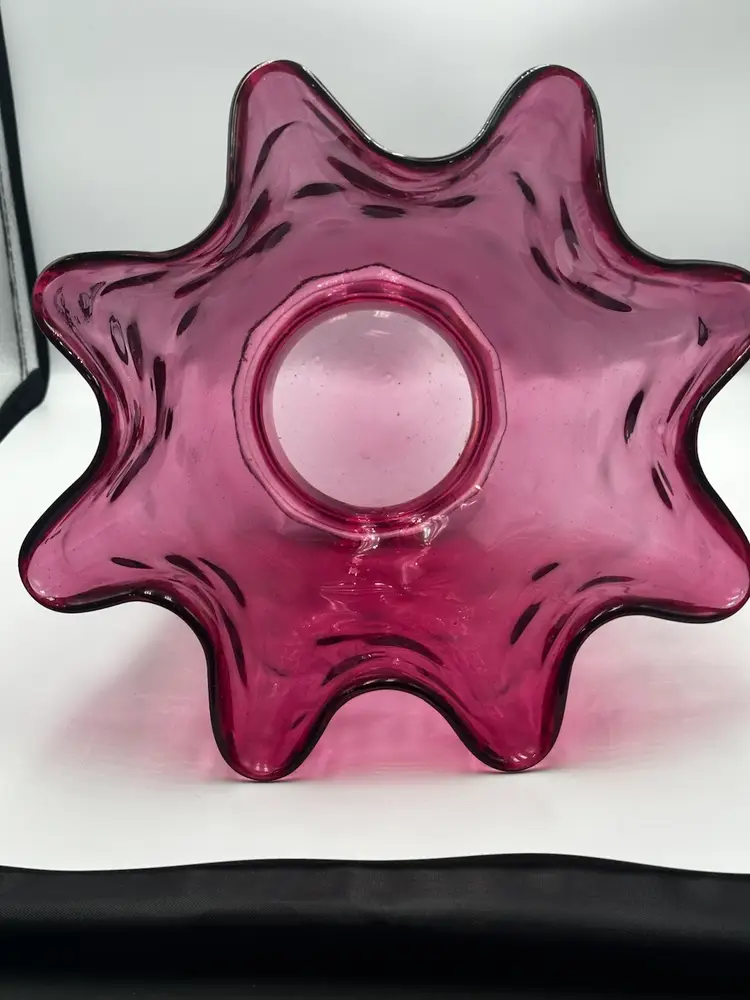 A12 Cranberry glass bowl with a ruffled edge and pedestal base