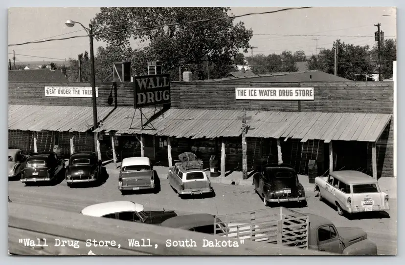 Postcard RPPC Wall Drug Store South Dakota Snoboy Bumper Sticker - 12805