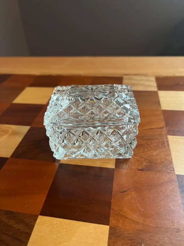 A vintage clear glass lidded trinket box with diamond cut patterns. 3”x2” X2”