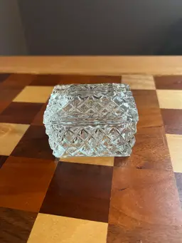 A vintage clear glass lidded trinket box with diamond cut patterns. 3”x2” X2”