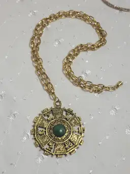 Vintage 1970s Chinese zodiac goldtone pendant and necklace with green with glitter resin center
