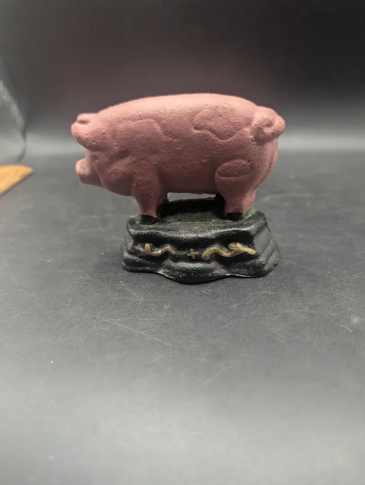 Vintage Cast Iron Pink Pig Door Stop on Green Base.