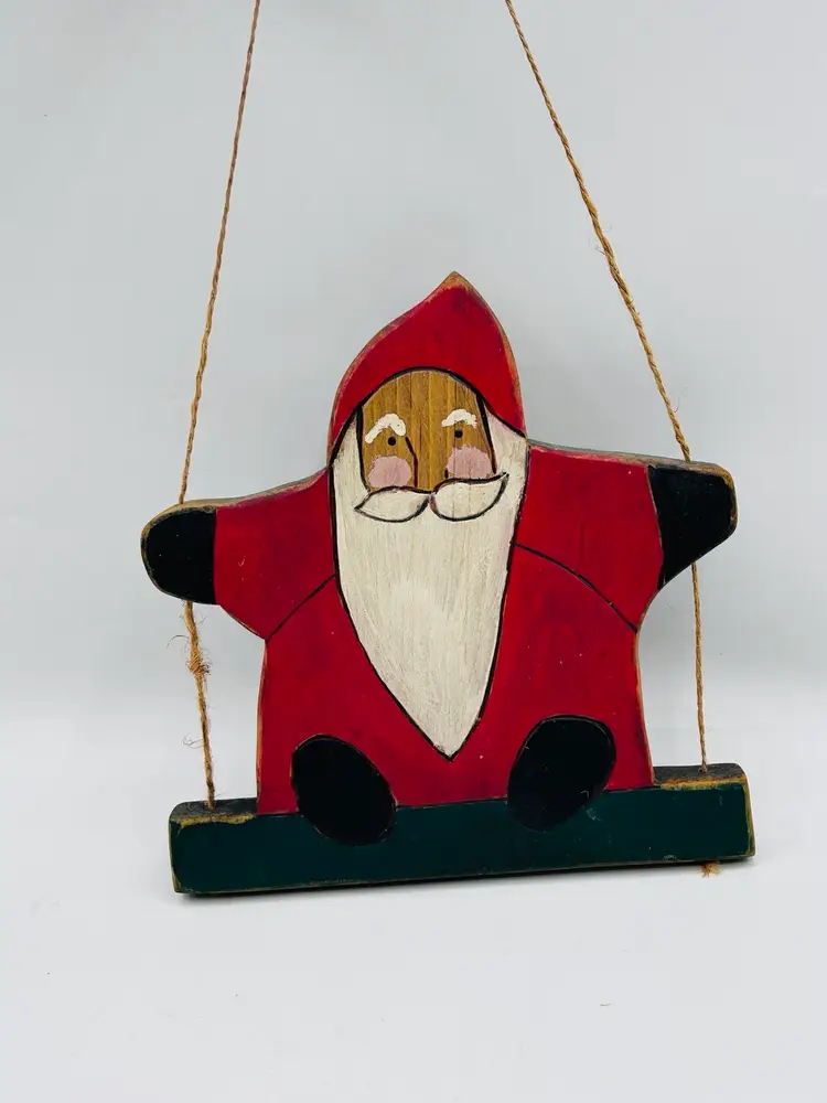 Primitive hand carved Santa on swing art