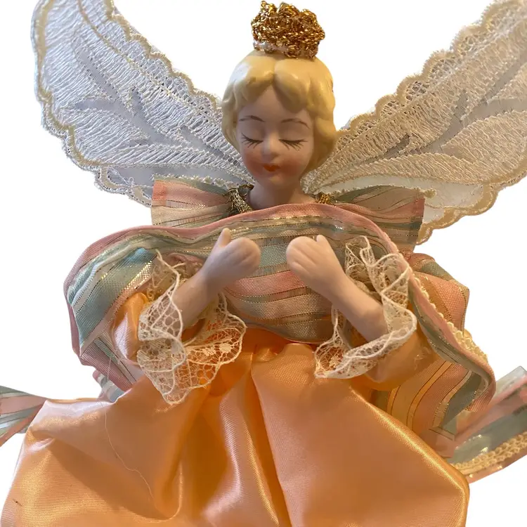 vintage Christmas angel tree topper, featuring porcelain hands and head, designed to sit atop a tree or table. Peach
